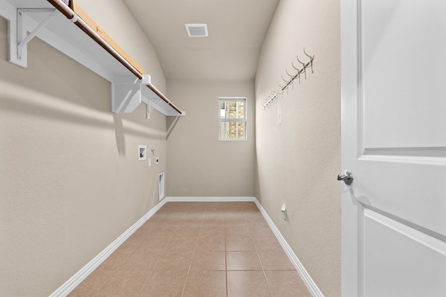 laundry area featuring gas dryer hookup, hookup for a washing machine, hookup for an electric dryer, and light tile patterned floors