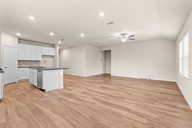 kitchen with light hardwood / wood-style flooring, white cabinetry, ceiling fan, and an island with sink