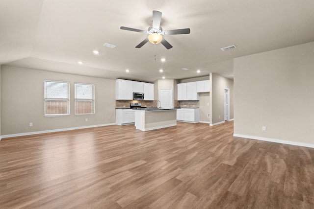 unfurnished living room featuring light hardwood / wood-style floors and ceiling fan