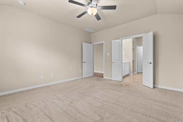 unfurnished bedroom with lofted ceiling, light colored carpet, and ceiling fan