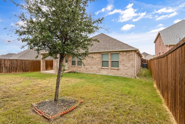 rear view of property featuring a patio, a lawn, and central air condition unit