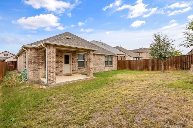 back of house featuring a yard and a patio area