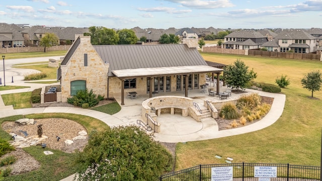 rear view of property with a yard and a patio