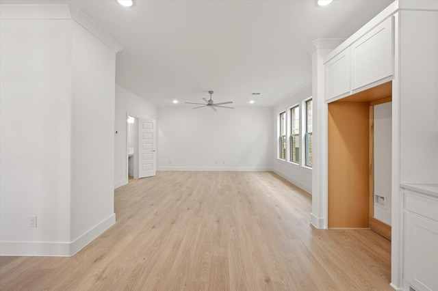 unfurnished living room with ceiling fan and light hardwood / wood-style flooring