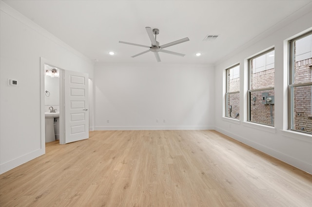 empty room with ceiling fan, ornamental molding, and light hardwood / wood-style flooring