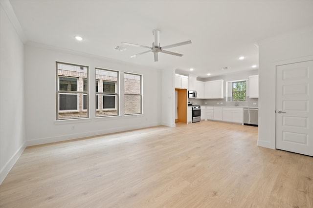 unfurnished living room featuring sink, ceiling fan, ornamental molding, and light hardwood / wood-style flooring