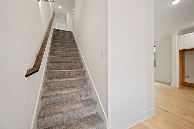 stairs featuring hardwood / wood-style flooring