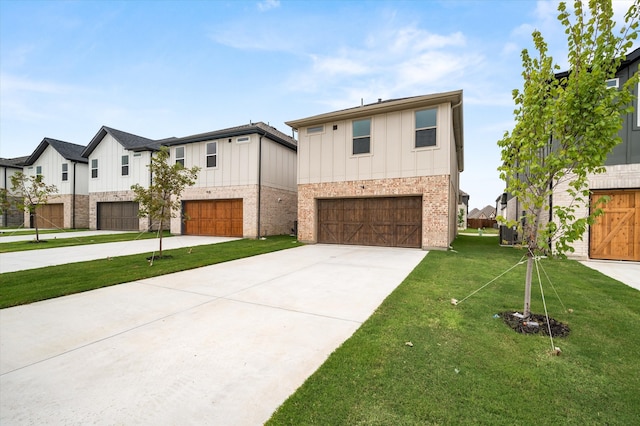 view of front of property featuring a front yard and a garage