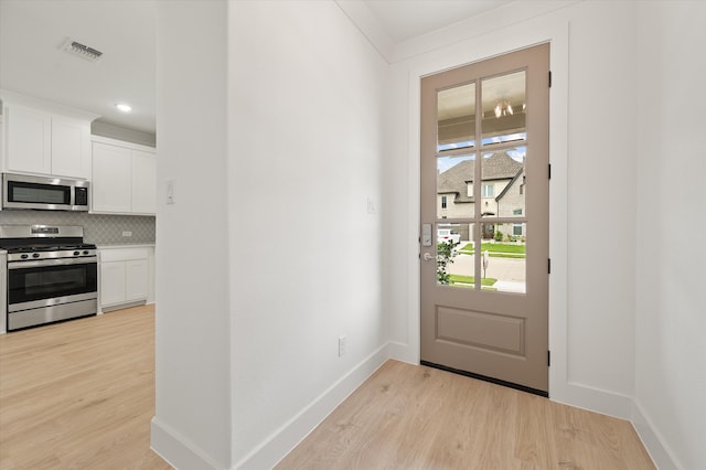 doorway to outside featuring light wood-type flooring