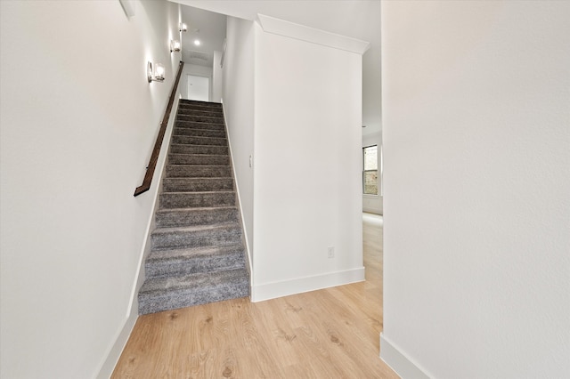 stairs featuring hardwood / wood-style floors