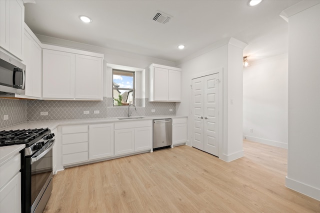 kitchen featuring light hardwood / wood-style floors, white cabinets, and stainless steel appliances