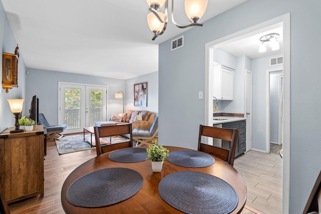 dining area with a notable chandelier and sink