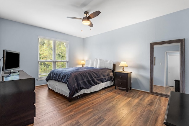 bedroom with dark hardwood / wood-style floors and ceiling fan