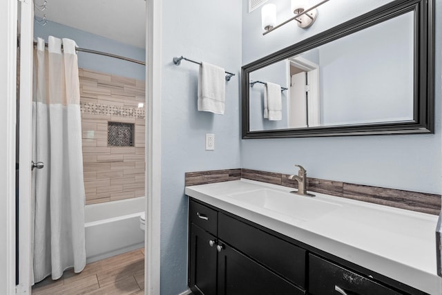 full bathroom with shower / tub combo, vanity, and toilet