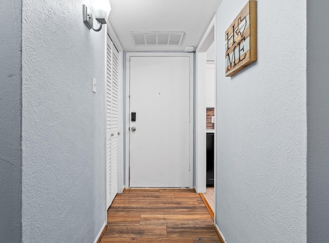 hallway with dark hardwood / wood-style flooring