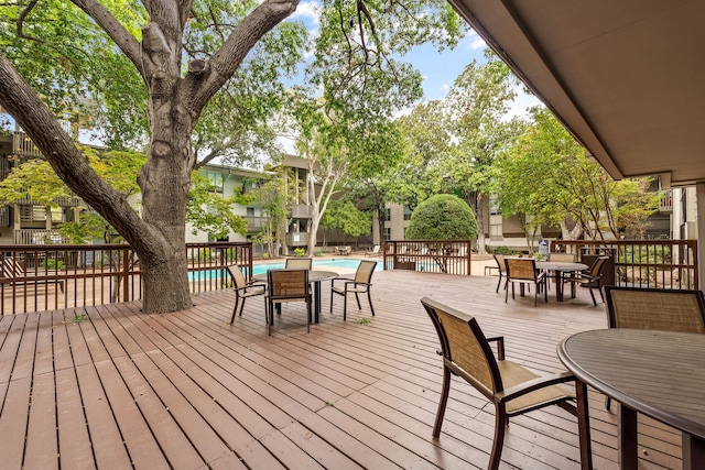 wooden deck featuring a fenced in pool