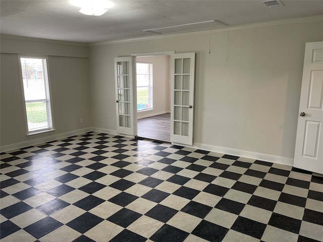 empty room with french doors, a textured ceiling, plenty of natural light, and ornamental molding