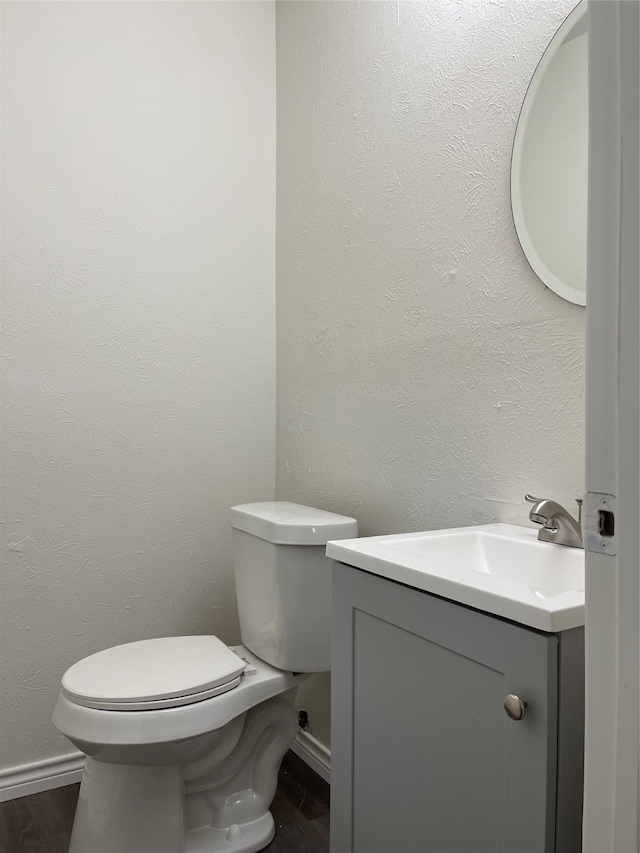 bathroom featuring hardwood / wood-style floors, vanity, and toilet