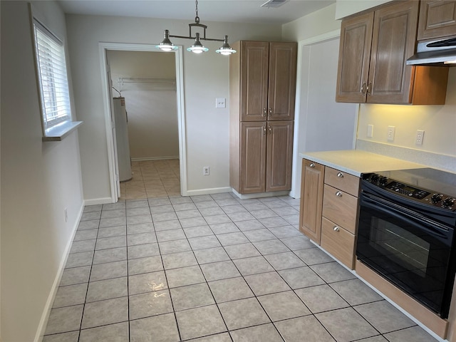 kitchen featuring black range with electric cooktop, water heater, exhaust hood, light tile patterned floors, and hanging light fixtures