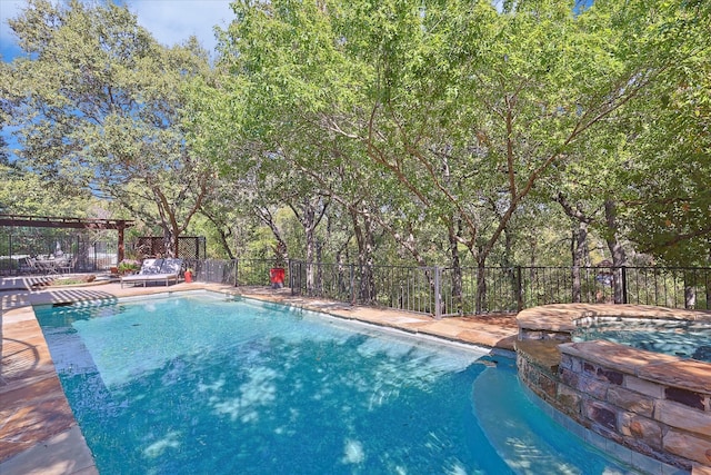 view of pool with an in ground hot tub