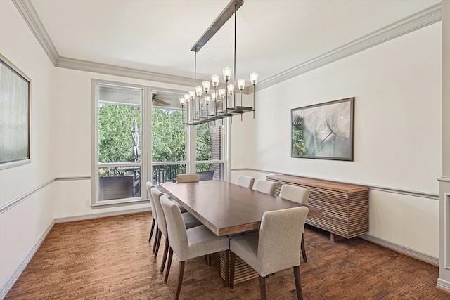 dining room with ornamental molding, a notable chandelier, and dark hardwood / wood-style floors