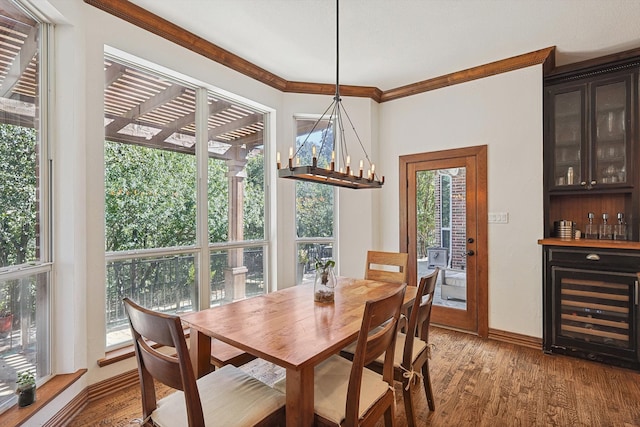 dining room with hardwood / wood-style flooring, ornamental molding, a chandelier, and plenty of natural light