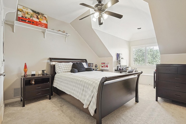 carpeted bedroom with ceiling fan and lofted ceiling