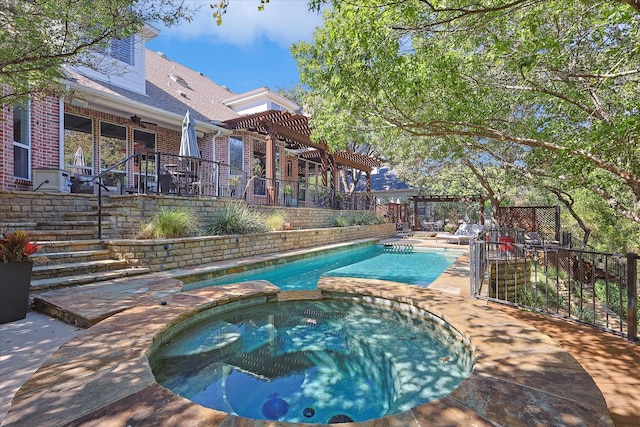 view of swimming pool with an in ground hot tub, ceiling fan, and a patio area