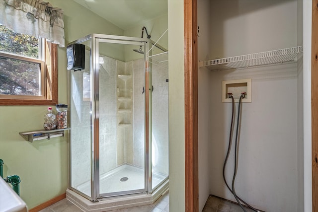 bathroom featuring a shower with door and tile patterned flooring