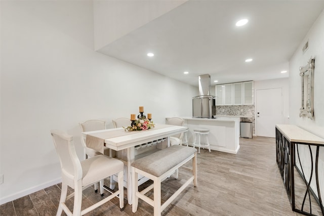 dining room with light hardwood / wood-style flooring