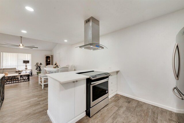 11306 Park Central Pl Unit D, Dallas, TX 75230 - kitchen with stainless steel appliances, island range hood, a peninsula, light wood-type flooring, and recessed lighting