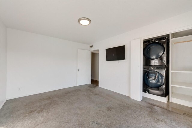 11306 Park Central Pl Unit D, Dallas, TX 75230 - spare room with stacked washing machine and dryer and carpet