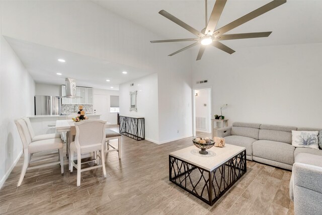 11306 Park Central Pl Unit D, Dallas, TX 75230 - living room featuring light wood finished floors, baseboards, high vaulted ceiling, recessed lighting, and ceiling fan
