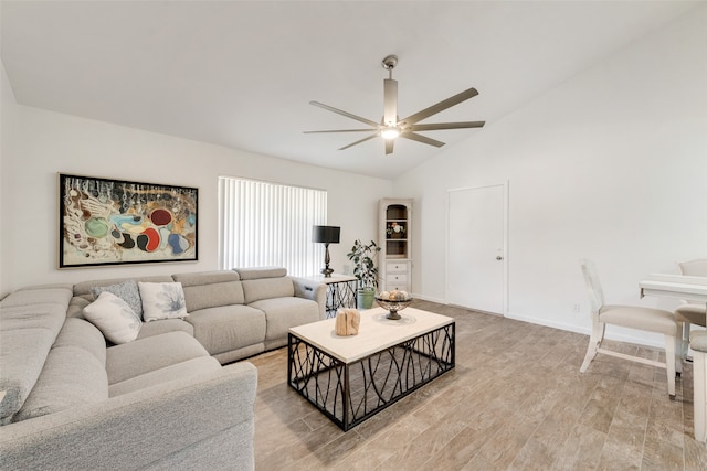 living room with light hardwood / wood-style floors, vaulted ceiling, and ceiling fan