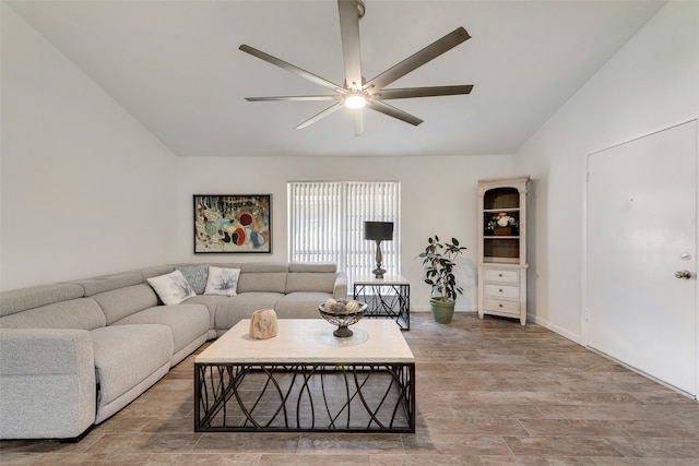 living room with ceiling fan, hardwood / wood-style flooring, and lofted ceiling