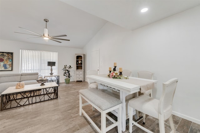 dining room with vaulted ceiling, light hardwood / wood-style flooring, and ceiling fan