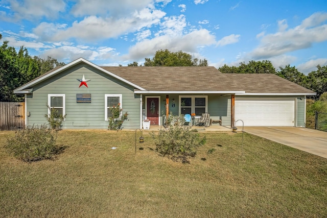 single story home with a porch, a front yard, and a garage