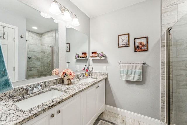 bathroom with vanity, hardwood / wood-style flooring, and a shower with shower door