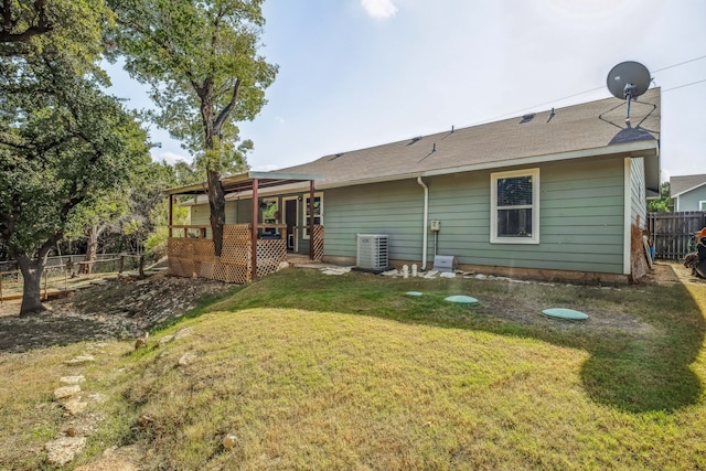 back of house with a yard and central AC unit