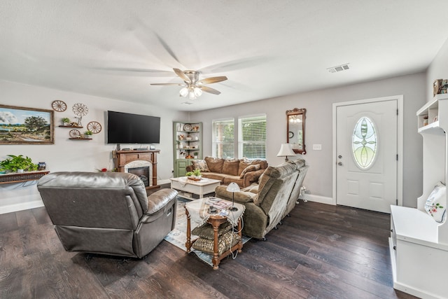 living room featuring dark wood-type flooring and ceiling fan