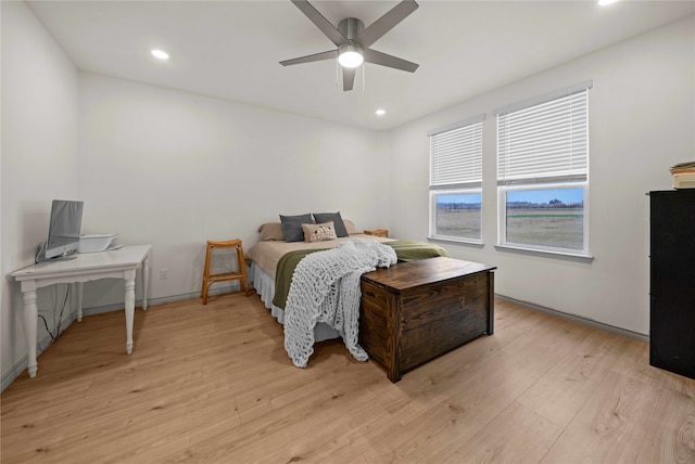 bedroom with light hardwood / wood-style flooring and ceiling fan