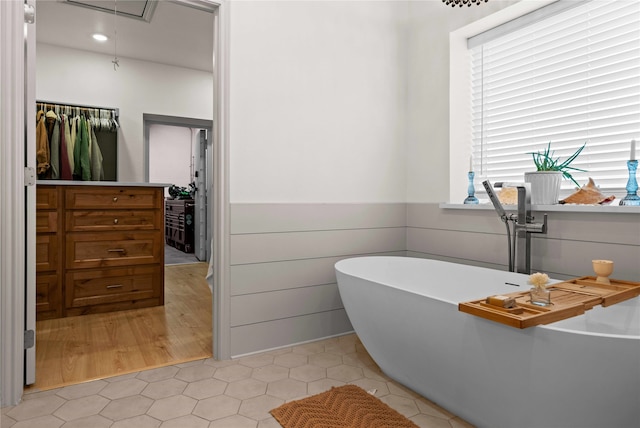 bathroom featuring tile patterned flooring and a bathtub