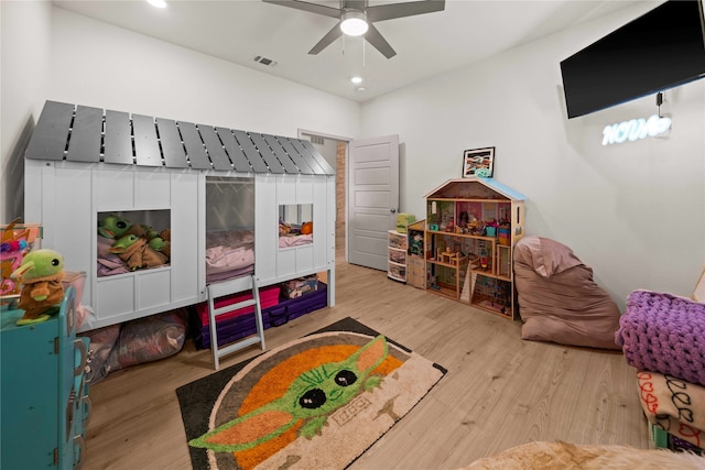 rec room with light wood-type flooring and ceiling fan