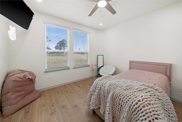 bedroom with ceiling fan and light wood-type flooring