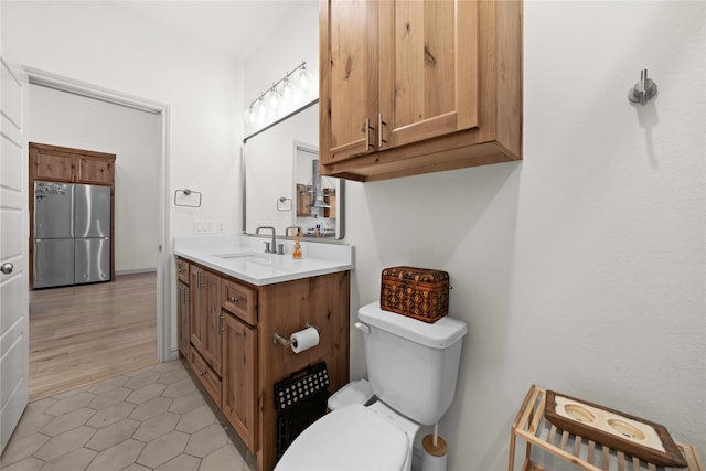 bathroom with vanity, tile patterned floors, and toilet