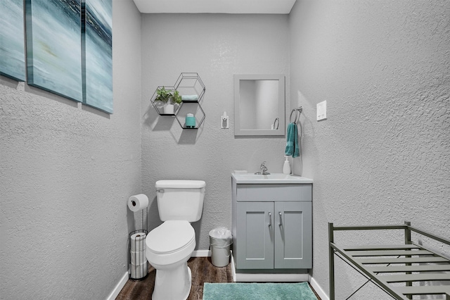 bathroom featuring vanity, toilet, and wood-type flooring