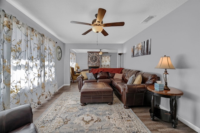 living room with dark hardwood / wood-style floors and ceiling fan