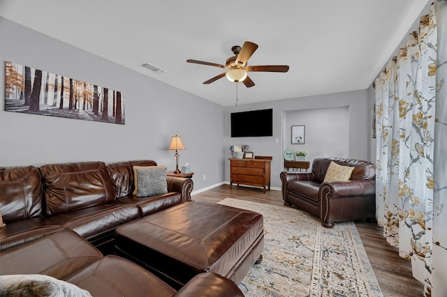 living room with ceiling fan and wood-type flooring