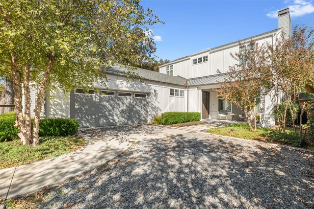 rear view of property featuring a garage