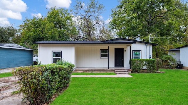 view of front of house with a porch and a front lawn